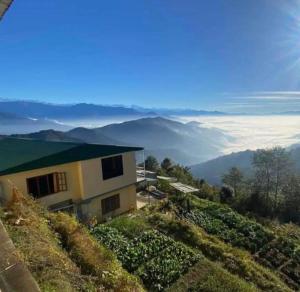 a house on a hill with a view of the mountains at Hotel Shangbola in Pāti Bhanjyāng
