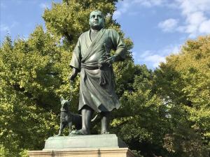 a statue of a man standing next to a dog at Hotel New Ueno in Tokyo