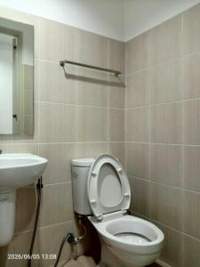 a bathroom with a toilet and a sink at Grand Riviera neas Slec in Manila +5 photos