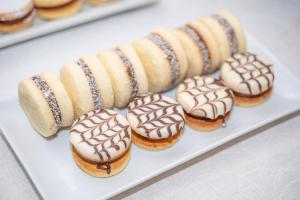 a plate of donuts with chocolate and peanut butter at Hotel Casagrande in Paysandú