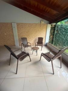 four chairs and a table on a patio at Casa Quinta Locha in Ciudad del Este