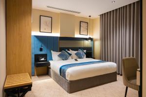 a hotel room with a bed and a chair at فندق لامار بارك - العليا in Tabuk