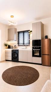 a kitchen with a sink and a refrigerator at Elite Residence in Accra +15 photos