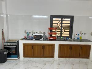 a kitchen with wooden cabinets and a counter top at Villa Jose in Sindia +6 photos
