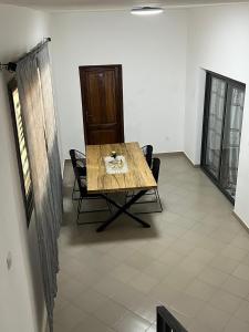 a dining room with a wooden table and chairs at Villa Jose in Sindia