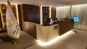 a lobby with a surfboard next to a reception desk at فندق لامار بارك - العليا in Tabuk