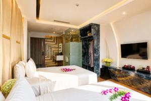 a hotel room with two beds and a television at W Premium Nha Trang in Nha Trang