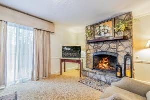 a living room with a stone fireplace at The Dillard House in Dillard
