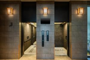 a hallway of a building with a tv on the wall at Anran Hotels&Resorts in Osaka +66 photos