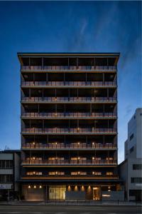 a tall building with many windows at night at Anran Hotels&Resorts in Osaka