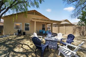 a group of chairs and a stone fire pit in front of a house at Sonesta Tucson in Tortolita