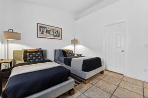a bedroom with two beds and a table and a desk at Sonesta Tucson in Tortolita