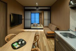 a kitchen and living room with a table and a couch at Anran Hotels&Resorts in Osaka