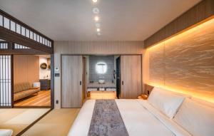 a bedroom with a large bed and a living room at Anran Hotels&Resorts in Osaka