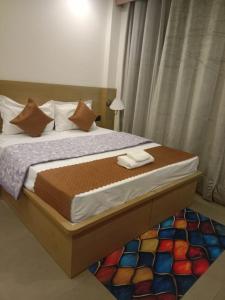 a bedroom with a large bed with a colorful rug at The Vista Retreat in Shimla