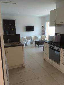 a kitchen and a living room with a couch at Monte san petru in Propriano