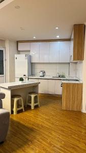 a kitchen with white cabinets and a counter and stools at 2 bed apartment in Buural