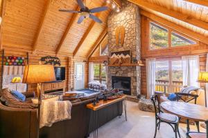 a living room with a fireplace in a log cabin at Angels Envy in Lenoir