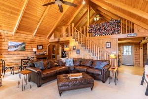 a living room with leather furniture and a wooden ceiling at Angels Envy in Lenoir +50 photos