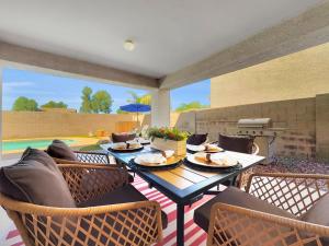 a dining room with a table and chairs and a patio at Karsten Maricopa in Maricopa