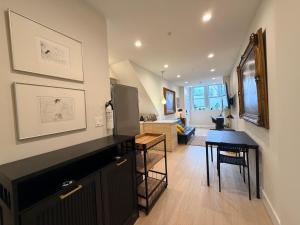 a living room with a kitchen and a dining room at The Hudson Horizon in West New York +20 photos