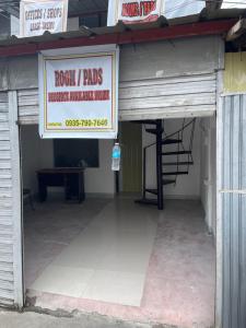a building with a sign for a garage at Kwarto-2-Go in Pontud +3 photos