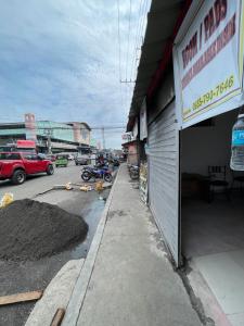 a street with a motorcycle parked next to a building at Kwarto-2-Go in Pontud