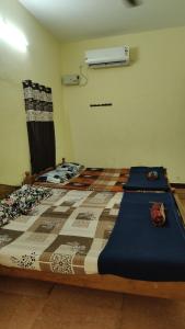 a bedroom with a bed with a quilt on it at The beach light in Auroville