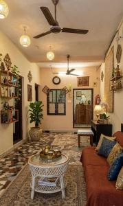 a living room with a couch and a table at The beach light in Auroville
