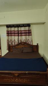 a bed in a room with a curtain and a bed sidx sidx sidx at The beach light in Auroville