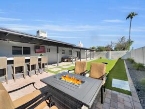 a patio with a table and chairs with a fire pit at Laurel Gilbert in Gilbert