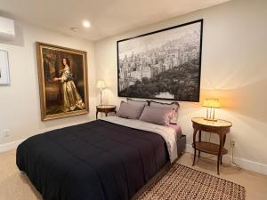 a bedroom with a bed and a painting on the wall at The Hudson Horizon in West New York