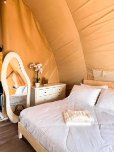 a bedroom with a bed in a tent at Reef Resort - Mount Apo View Unit B4 in Kaputian +9 photos