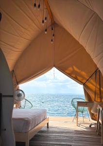a tent with a view of the ocean at Reef Resort - Mount Apo View Unit B4 in Kaputian