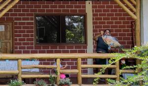 a man standing in front of a brick house at Sisa Lodge in Tena