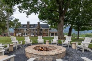 a group of chairs around a fire pit in front of a house at The Dillard House in Dillard