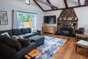 a living room with a couch and a fireplace at Dip and Dink Catskills Poolside Oasis in White Lake