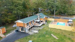 an aerial view of a house with a swimming pool at Dip and Dink Catskills Poolside Oasis in White Lake
