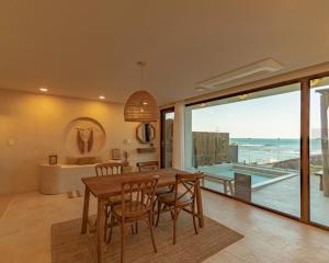 a dining room with a table and a view of the ocean at Ulsan Guyu Stay in Ulsan