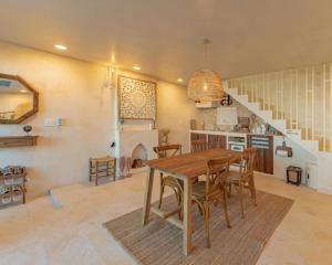 a kitchen and dining room with a wooden table and chairs at Ulsan Guyu Stay in Ulsan