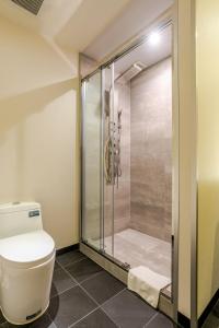 a bathroom with a shower and a toilet at Ski-in, Ski-out Iwatake Apartments in Hakuba +55 photos