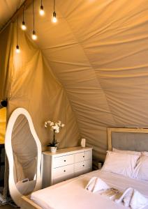 a bedroom with a tent with a bed and a dresser at Reef Resort - Samal Island View Unit B7 in Kaputian +7 photos