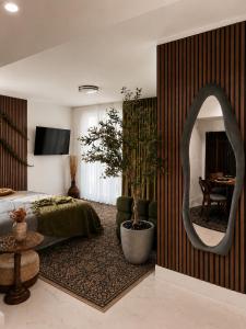 a bedroom with a mirror and a bed and a table at Oasis on Monroe Aparthotel in Hollywood