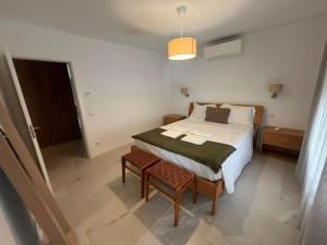 a small bedroom with a bed and a table at Terrace Ferragudo River View Flat Super in Ferragudo