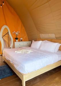 a bedroom with a bed in a tent at Reef Resort - Samal Island View Unit B8 in Kaputian