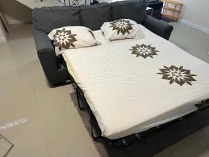 a bed with pillows on it in a room at Mandeville ingleside luxury in Mandeville