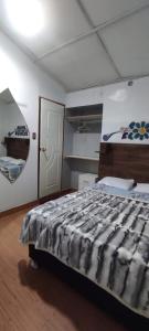 a bedroom with a large bed and a door at HOTEL CASA RUSTICA Jr CALLAO 264 HUAMANGA AYACUCHO in Ayacucho