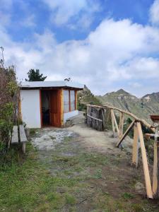 a small building with a bench in front of it at Urku Ñan Quilotoa in Sigchos