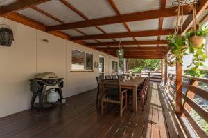 a dining room with a table and a grill at The Deck in Elizabeth Beach