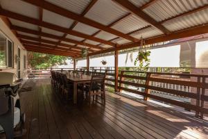 a dining room with a table and chairs on a deck at The Deck in Elizabeth Beach